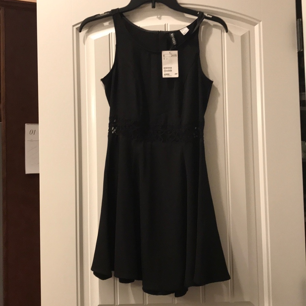 Black skater dress with lace in the mid area